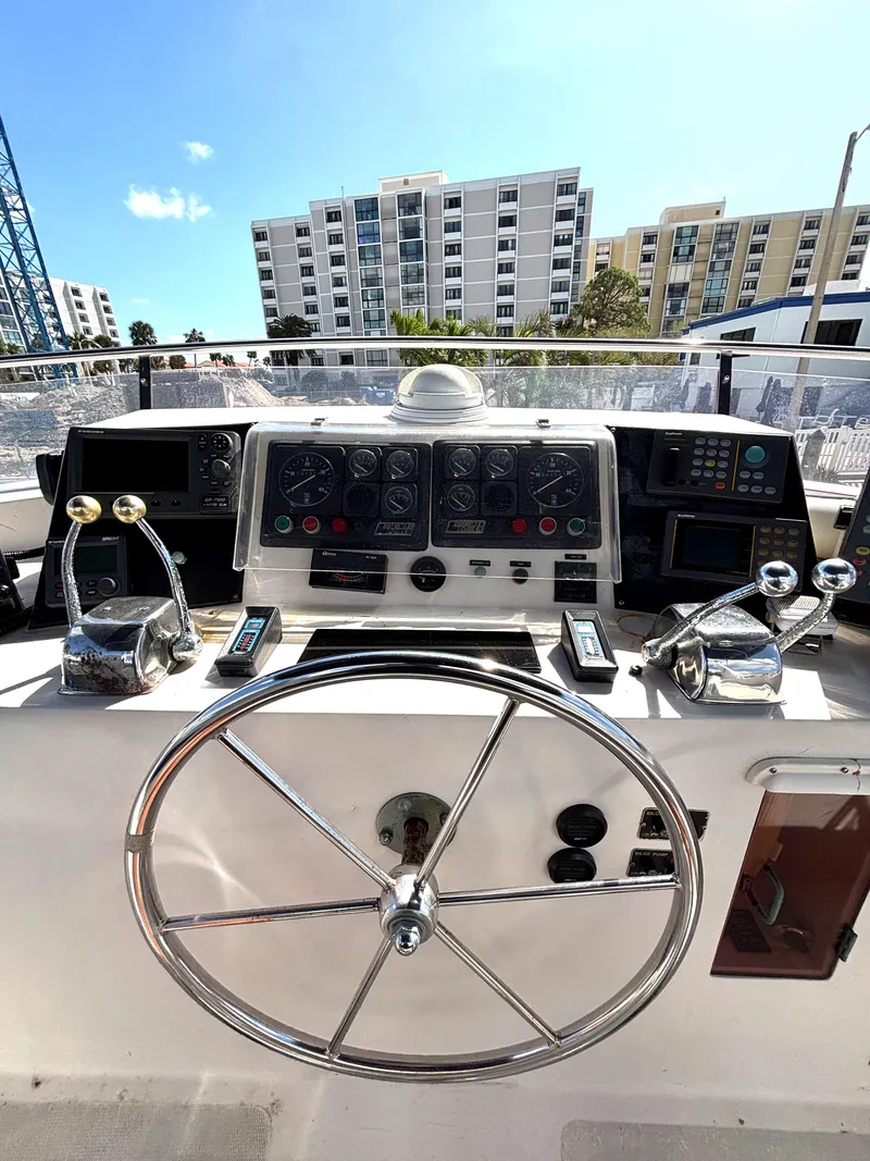 Slide: The Image of 1988 Marine Trader Tradewinds 43 Motor Yacht helm with cityscape background. - 16