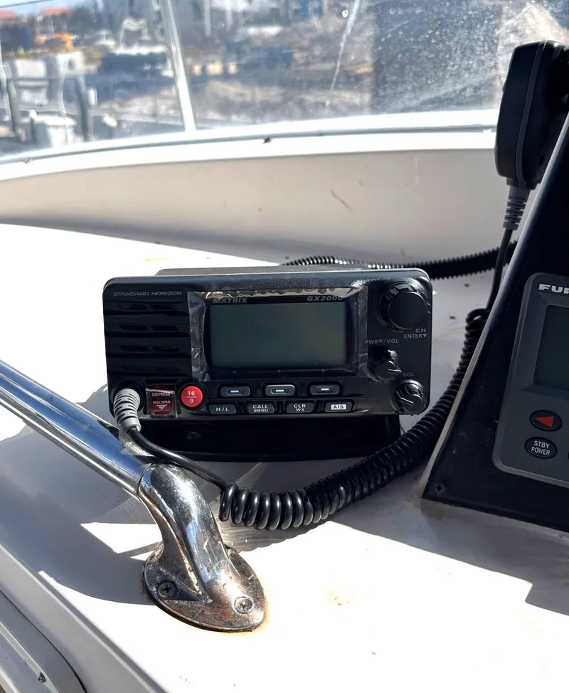 Slide: The Image of Marine Trader Tradewinds 43 Motor Yacht 1988, featuring a modern radio system on the dashboard. - 17