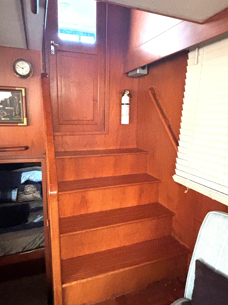 Slide: The Image of Interior stairs of 1988 Marine Trader Tradewinds 43 Motor Yacht with wooden finish. - 23