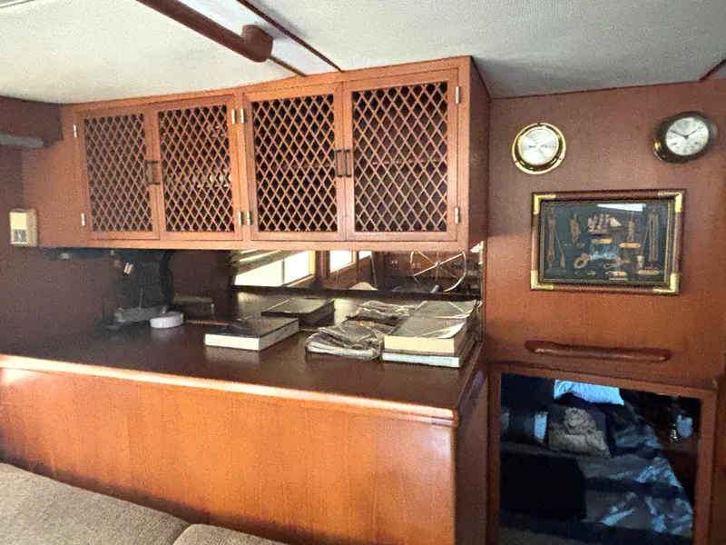 Slide: The Image of Interior of 1988 Marine Trader Tradewinds 43 Motor Yacht with wooden cabinetry and nautical decor. - 24