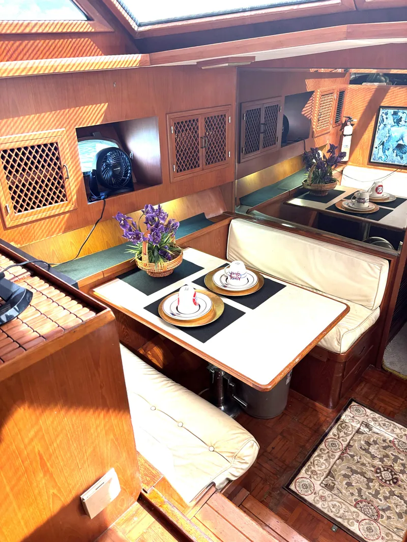 Slide: The Image of Interior of 1988 Marine Trader Tradewinds 43 Motor Yacht with cozy dining area and decor. - 27