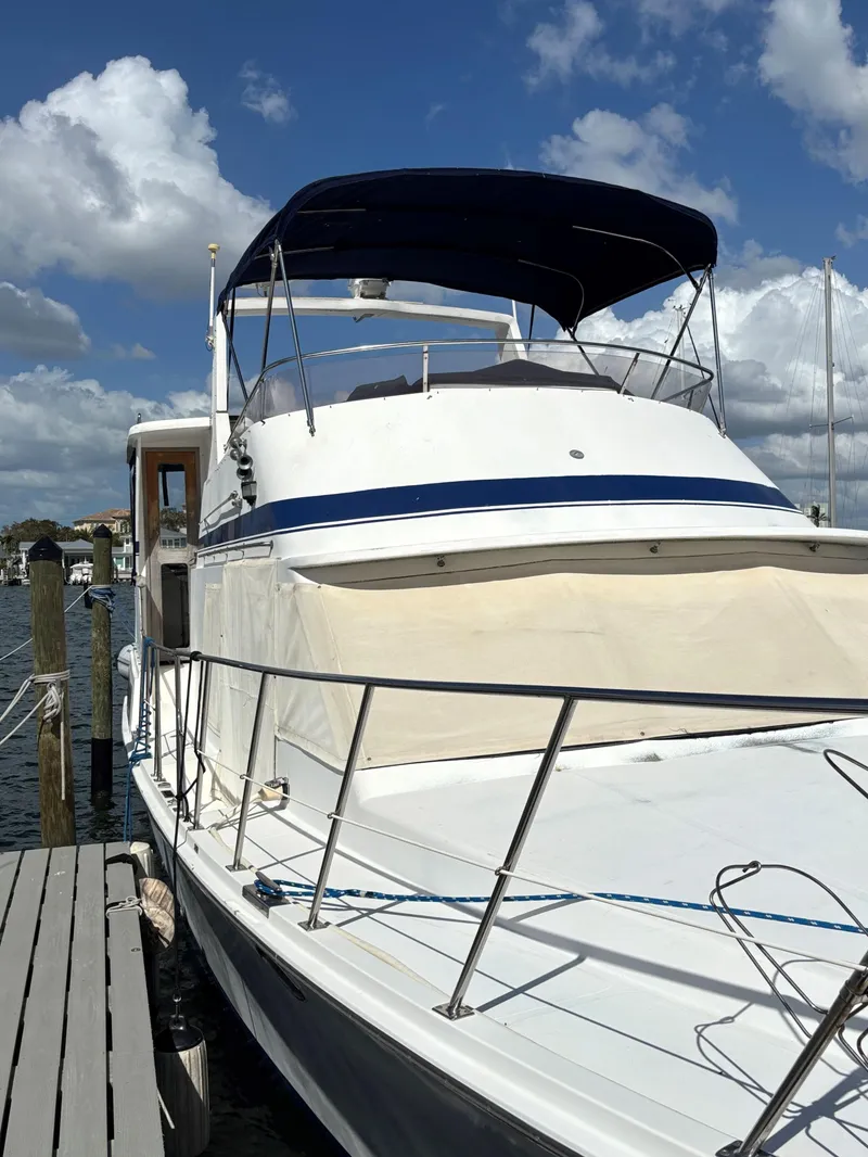 Slide: The Image of 1988 Marine Trader Tradewinds 43 Motor Yacht docked under blue sky. - 3