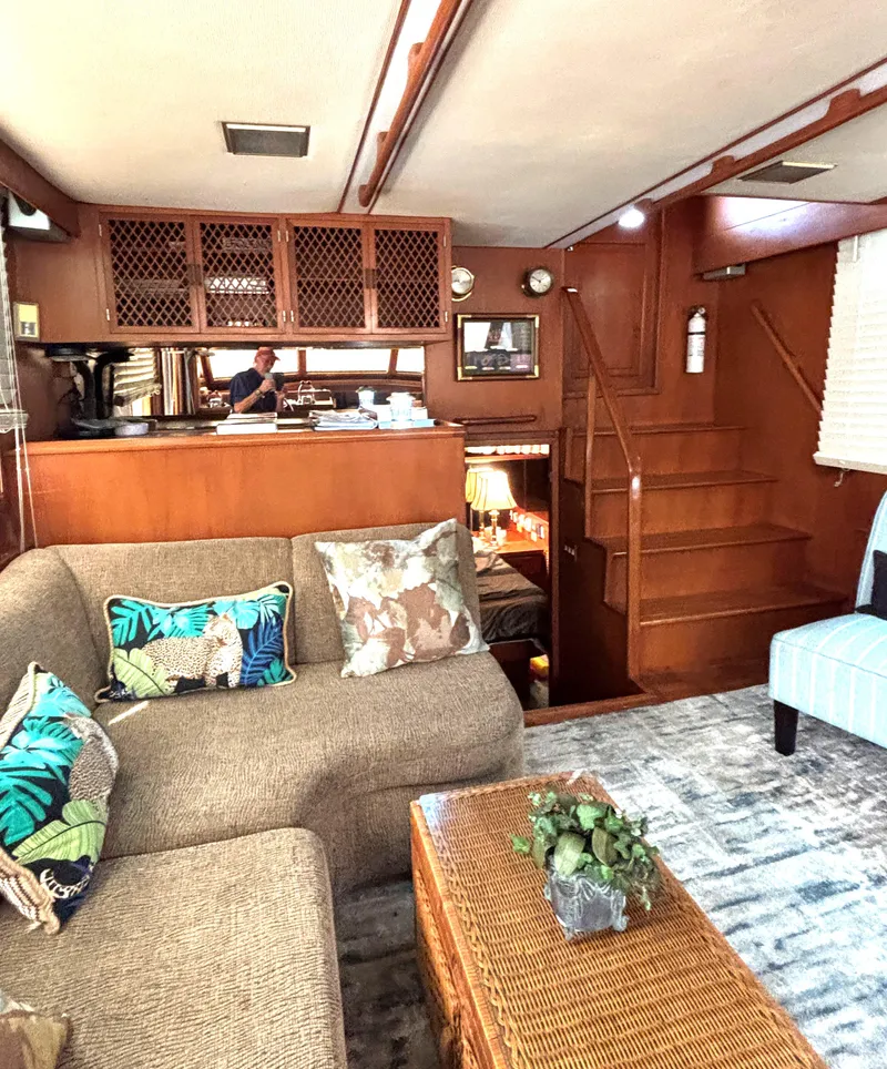 Slide: The Image of Interior of 1988 Marine Trader Tradewinds 43 Motor Yacht, featuring cozy seating and wooden accents. - 32