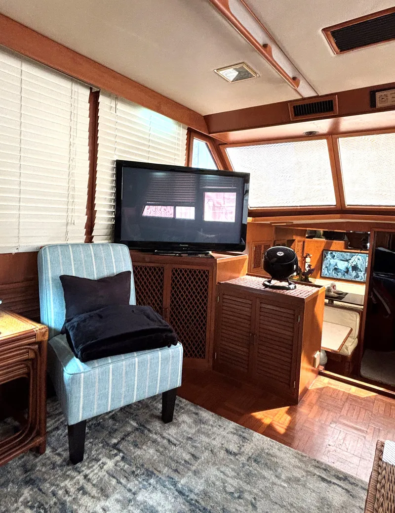 Slide: The Image of Interior of 1988 Marine Trader Tradewinds 43 Motor Yacht with cozy seating and entertainment area. - 33