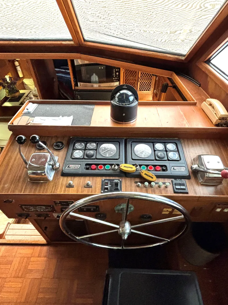Slide: The Image of 1988 Marine Trader Tradewinds 43 Motor Yacht helm with steering wheel and control panel. - 36