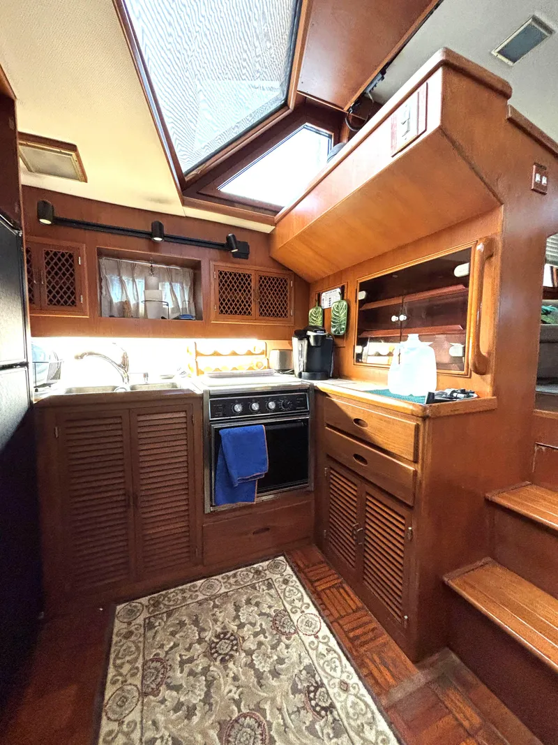 Slide: The Image of 1988 Marine Trader Tradewinds 43 Motor Yacht kitchen with wood cabinetry and skylight. - 41