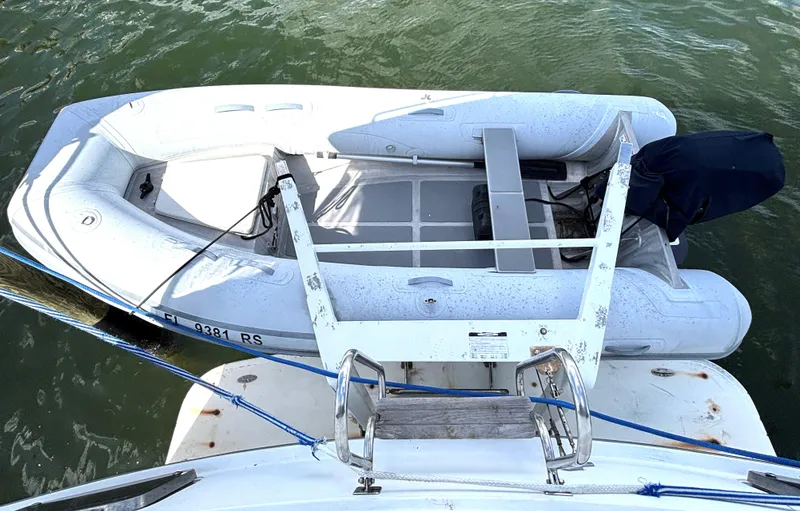 Slide: The Image of 1988 Marine Trader Tradewinds 43 Motor Yacht with inflatable dinghy on water. - 9