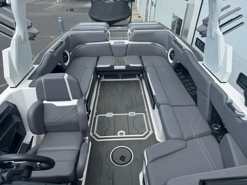 Slide: The Image of 2023 Supra SE 550 boat interior with sleek gray seating and modern design. - 10