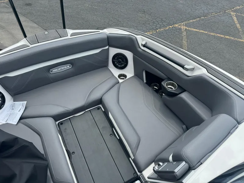 Slide: The Image of 2023 Supra SE 550 boat interior with gray seating and speaker system. - 11