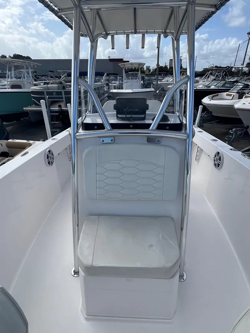 Slide: The Image of 2023 Aquasport 22 CC center console boat with seating, docked in a marina. - 5