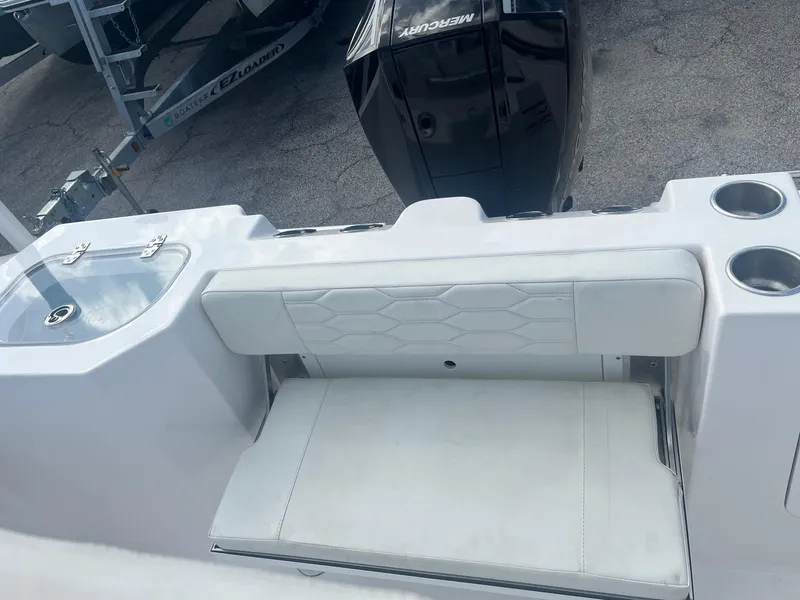 Slide: The Image of 2023 Aquasport 22 CC boat interior with seating and cup holders. - 6