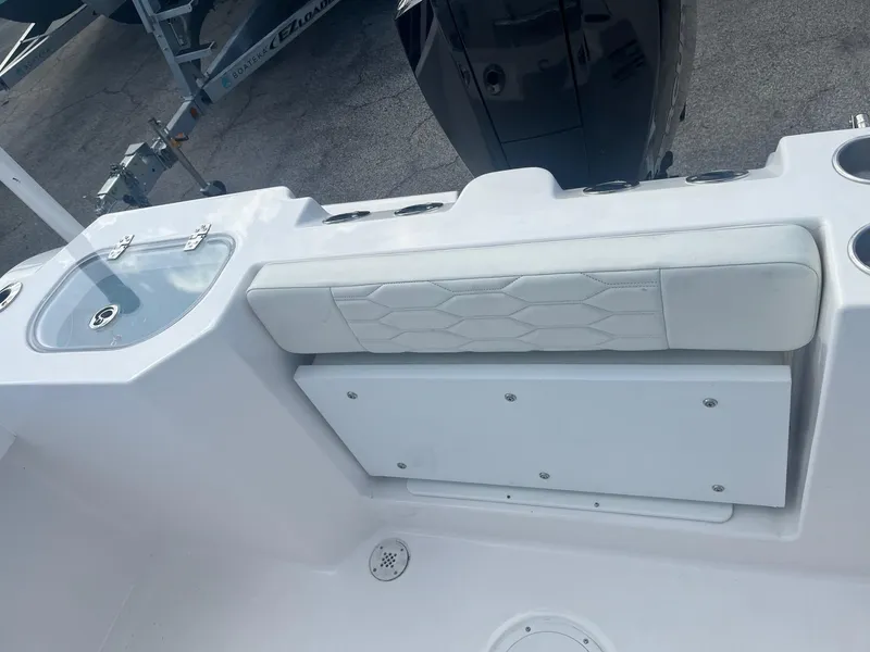 Slide: The Image of 2023 Aquasport 22 CC boat interior with seating and storage. - 7