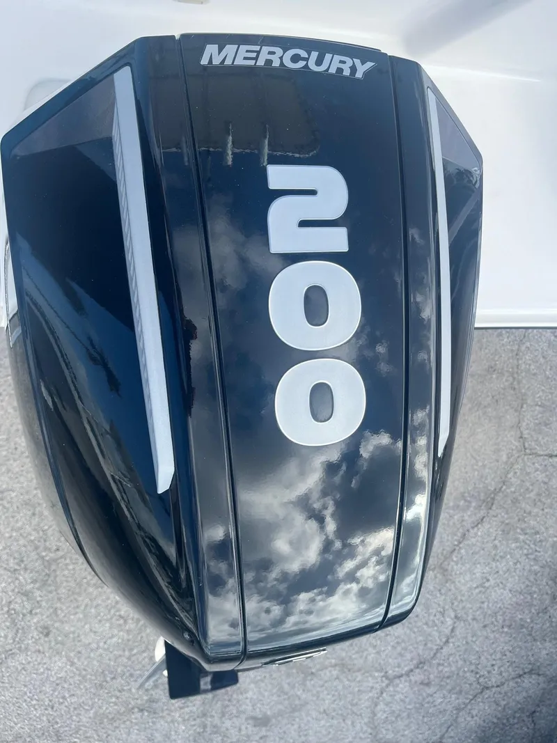 Slide: The Image of Mercury 200 outboard motor on 2023 Aquasport 22 CC boat, reflecting sky. - 8