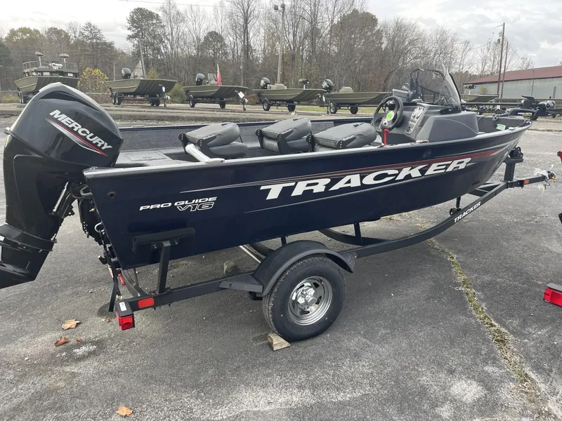 Slide: The Image of 2025 Tracker Pro Guide V-16 SC fishing boat with Mercury outboard motor on trailer. - 2