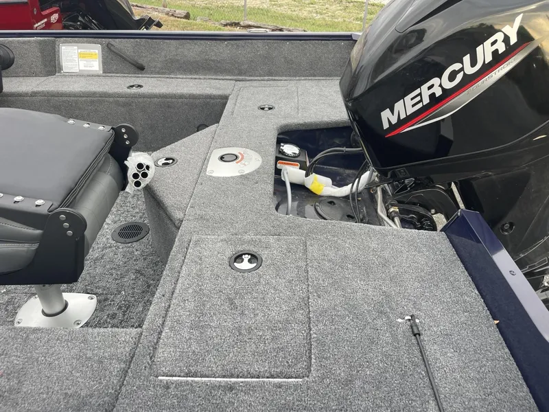 Slide: The Image of 2025 Tracker Pro Guide V-16 SC boat interior with Mercury engine. - 4