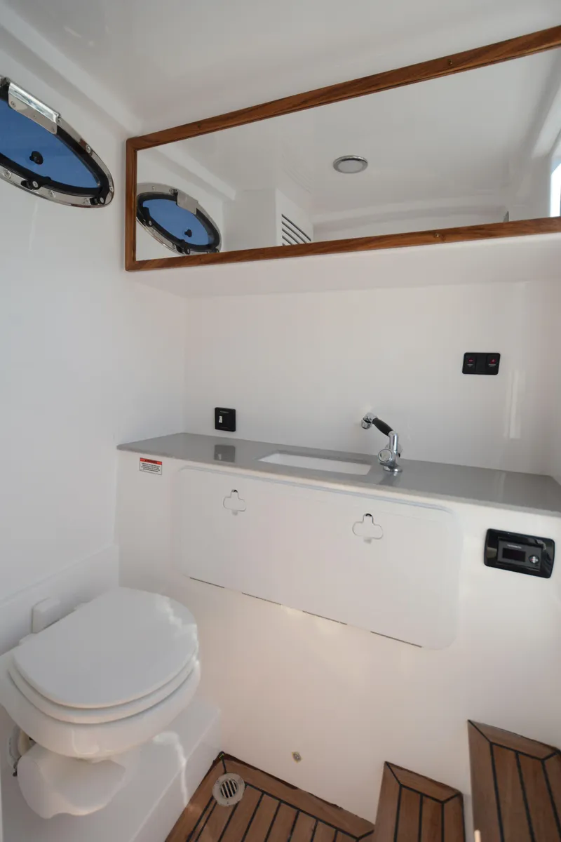 Slide: The Image of 2025 Marlago 37 SS boat bathroom with modern fixtures and wooden accents. - 11