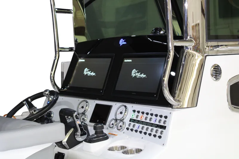 Slide: The Image of 2025 Marlago 37 SS boat dashboard with advanced controls and Garmin displays. - 2
