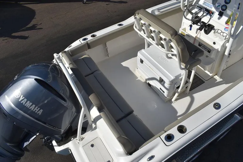 Slide: The Image of 2022 Key West 219fs boat interior with Yamaha engine, featuring seating and console. - 12