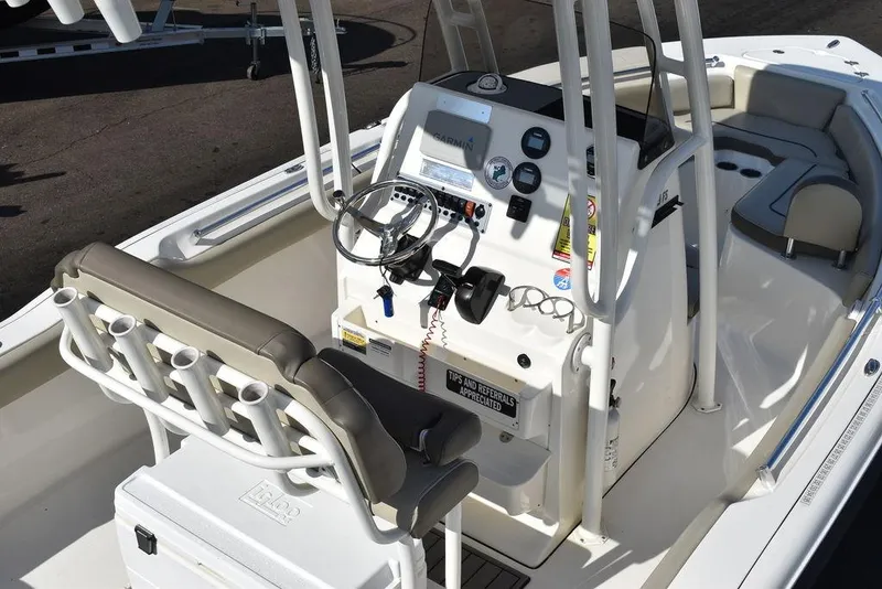 Slide: The Image of 2022 Key West 219fs boat interior with steering console and seating. - 13