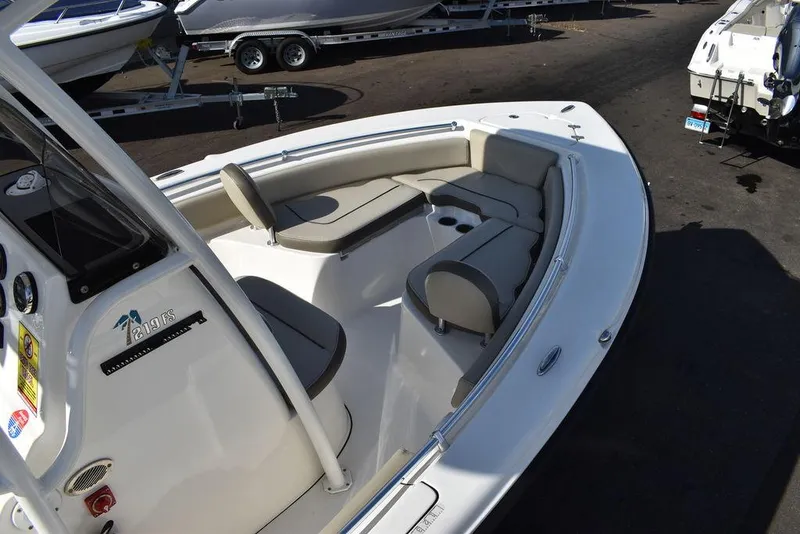 Slide: The Image of 2022 Key West 219fs boat interior with cushioned seating and cup holders. - 18