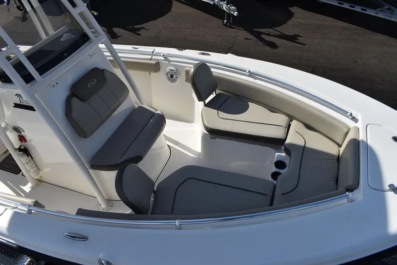 Slide: The Image of 2022 Key West 219fs boat interior with cushioned seating and cup holders. - 20