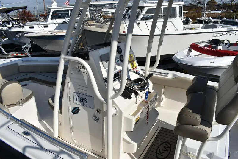 Slide: The Image of 2022 Key West 219fs boat interior with steering console and seating. - 25