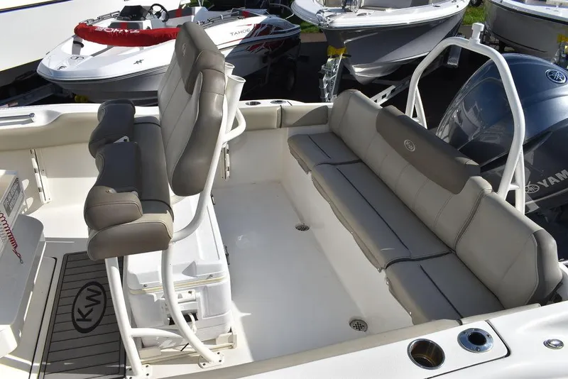 Slide: The Image of 2022 Key West 219fs boat interior with cushioned seating and helm. - 26