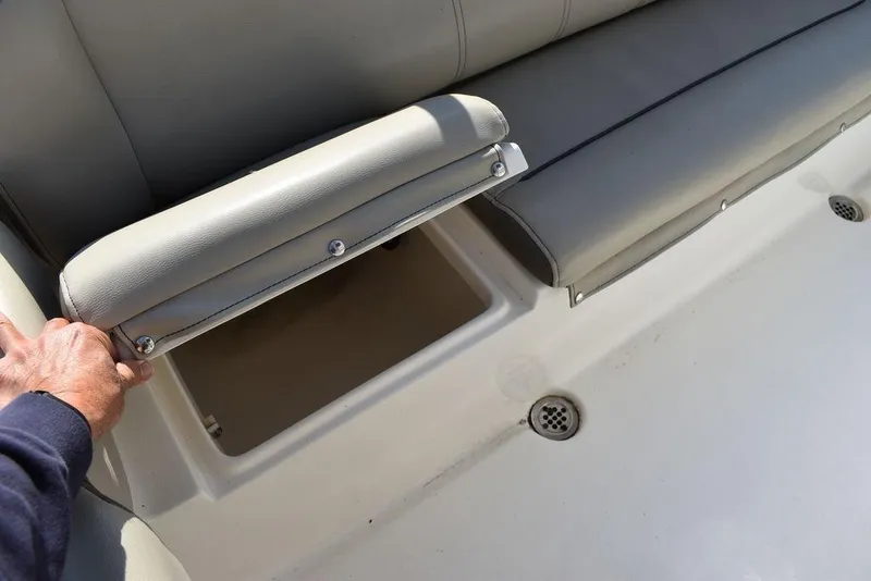 Slide: The Image of Key West 219fs 2022 boat seat with storage compartment open. - 29