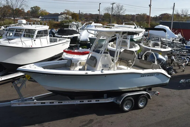 Slide: The Image of 2022 Key West 219fs boat on trailer in marina lot. - 3