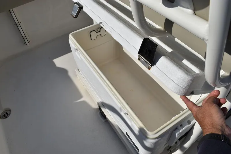 Slide: The Image of Key West 219fs 2022 boat cooler storage compartment with open lid. - 35