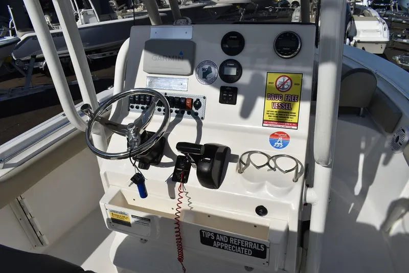 Slide: The Image of 2022 Key West 219fs boat console with steering wheel and controls. - 37