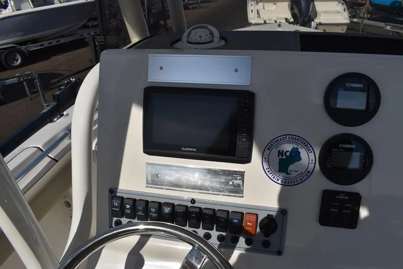 Slide: The Image of Key West 219fs 2022 boat dashboard with Garmin display and control panel. - 38