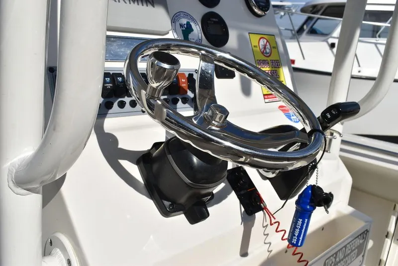Slide: The Image of Steering wheel of 2022 Key West 219fs boat, featuring modern controls and dashboard. - 43