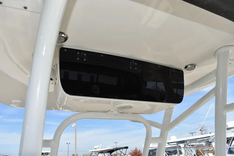 Slide: The Image of 2022 Key West 219fs boat console with black panel under clear blue sky. - 46