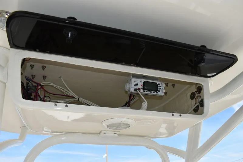 Slide: The Image of Key West 219fs 2022 boat console with open storage and electronic equipment. - 47