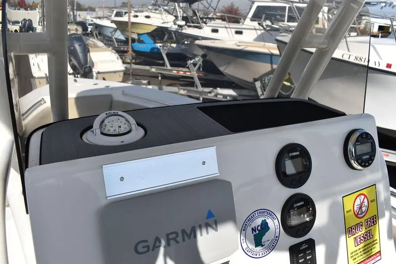 Slide: The Image of Key West 219fs 2022 boat dashboard with Garmin equipment and compass. - 49