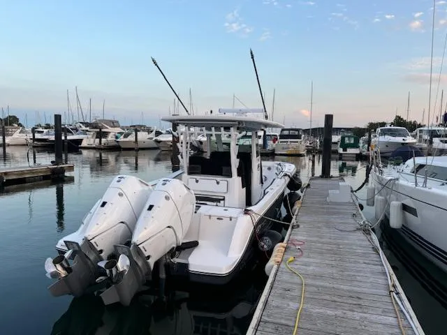 Slide: The Image of 2025 Crevalle 33 CTF boat docked at marina with twin outboard engines. - 11
