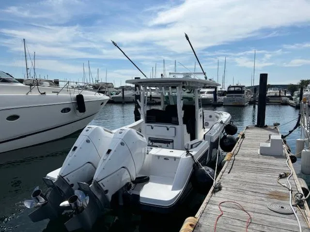 Slide: The Image of 2025 Crevalle 33 CTF boat docked at marina with twin engines. - 17