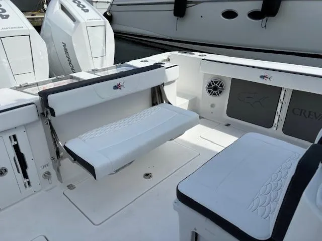Slide: The Image of 2025 Crevalle 33 CTF boat interior with seating and Mercury engines. - 4