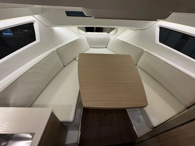 Slide: The Image of 2025 Jeanneau Leader 9.0 WA Series 2 cabin interior with seating and table. - 12