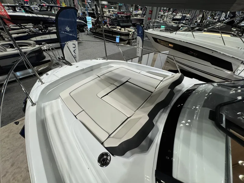 Slide: The Image of 2025 Jeanneau Leader 9.0 WA Series 2 boat with spacious deck seating at a boat show. - 17