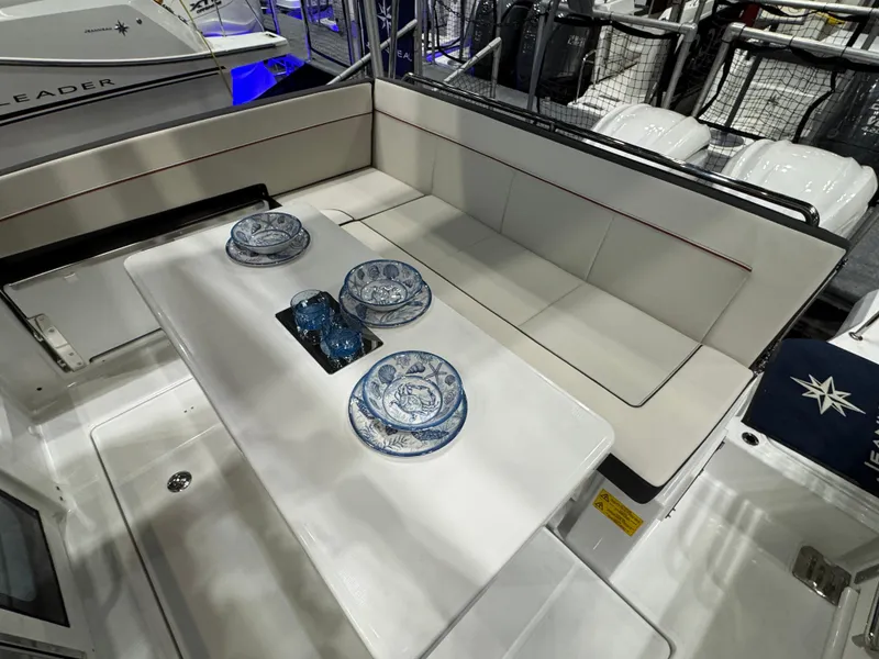 Slide: The Image of 2025 Jeanneau Leader 9.0 WA Series 2 boat interior with dining setup. - 2