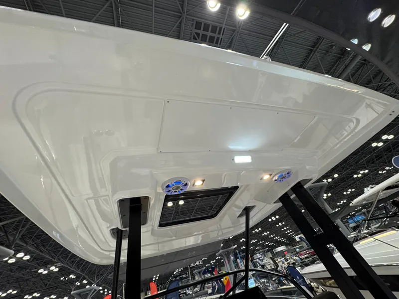 Slide: The Image of 2025 Jeanneau Leader 9.0 WA Series 2 boat underside view at an indoor exhibition. - 4