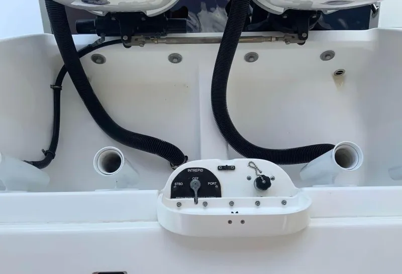 Slide: The Image of 2015 Intrepid 327 Center Console boat dashboard with controls and wiring. - 12