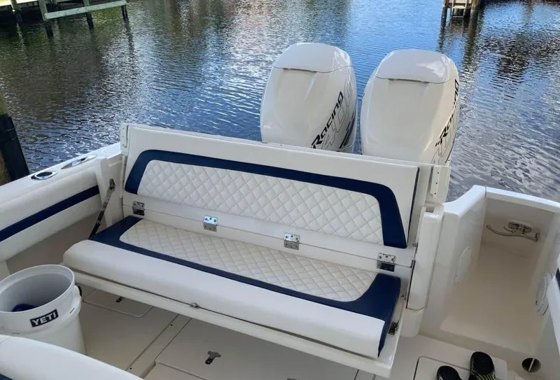 Slide: The Image of 2015 Intrepid 327 Center Console boat with dual engines and cushioned seating. - 15