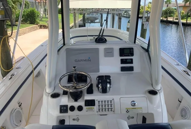 Slide: The Image of 2015 Intrepid 327 Center Console boat cockpit with Garmin navigation system. - 26