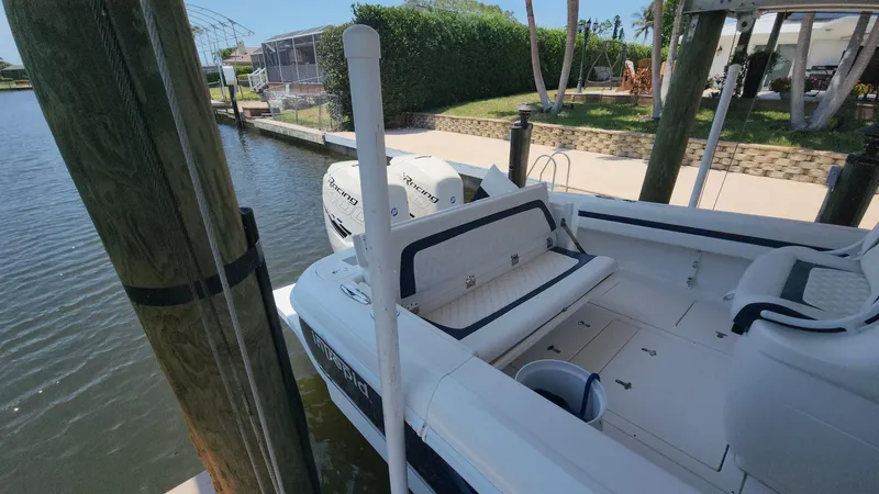 Slide: The Image of 2015 Intrepid 327 Center Console boat docked by a waterfront property. - 32