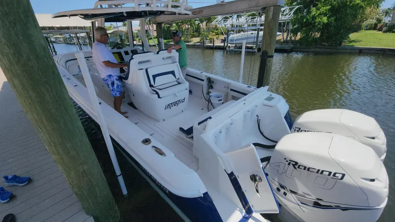 Slide: The Image of 2015 Intrepid 327 Center Console boat docked with twin racing engines. - 37