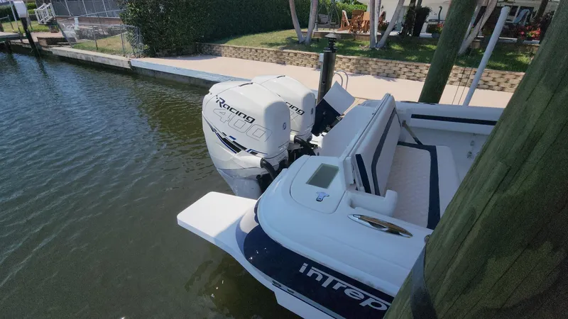 Slide: The Image of 2015 Intrepid 327 Center Console boat docked with powerful outboard engine. - 42