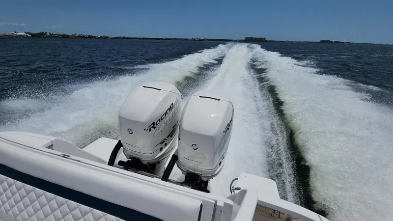 Slide: The Image of 2015 Intrepid 327 Center Console boat with twin engines cruising on open water. - 43